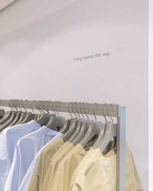 A picture of hanging dry cleaned shirts