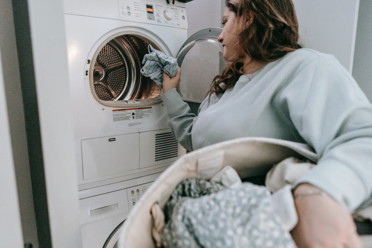 A woman loading the washer for the next wash
