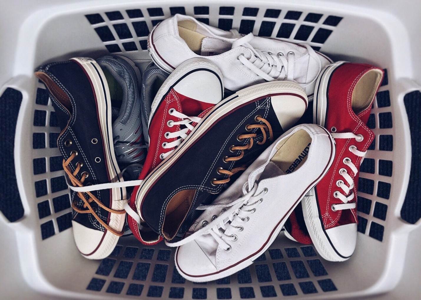  Different pairs of sneakers in the laundry basket
