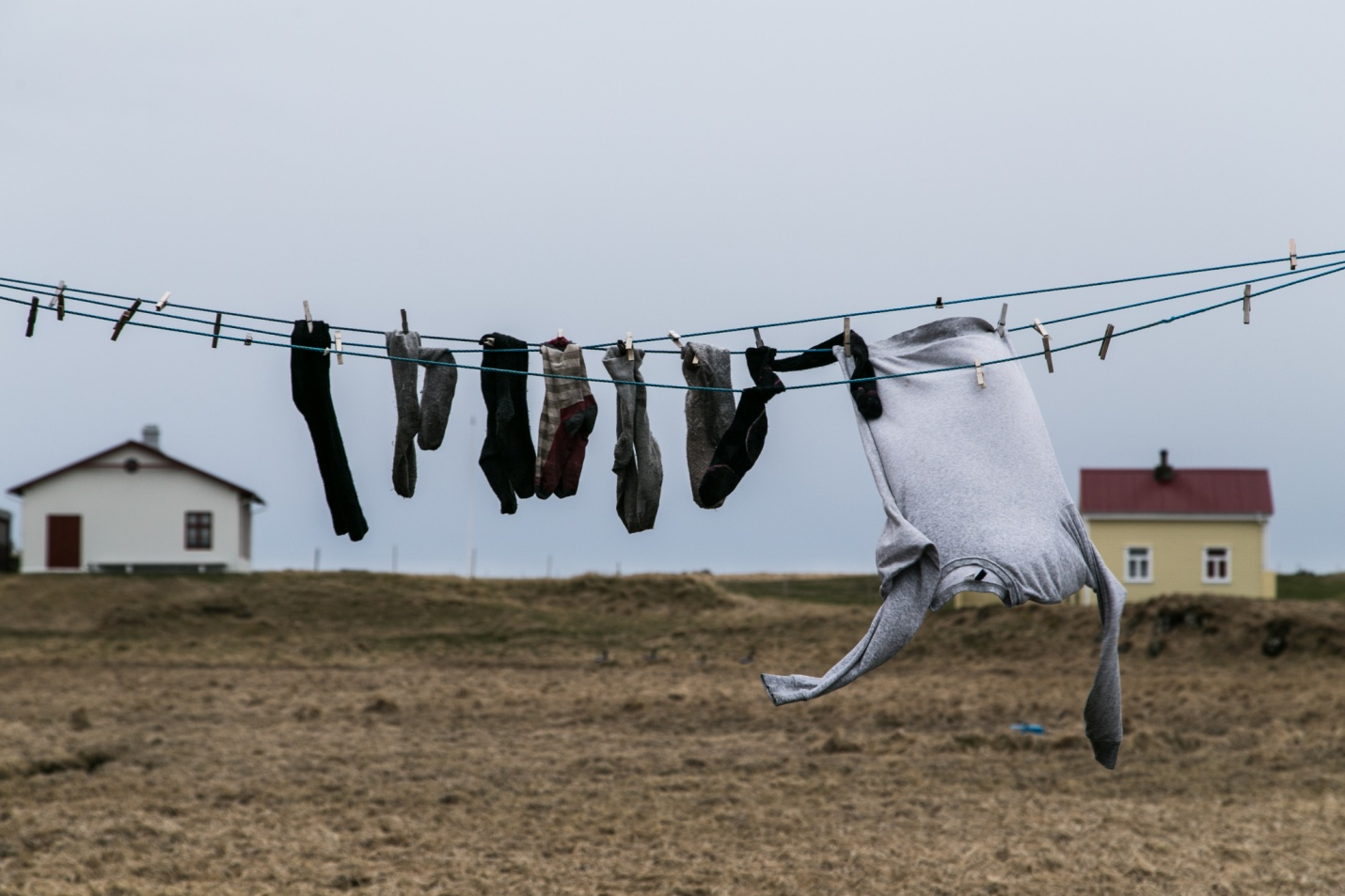 Socks and a jumper hanging on a wire for drying