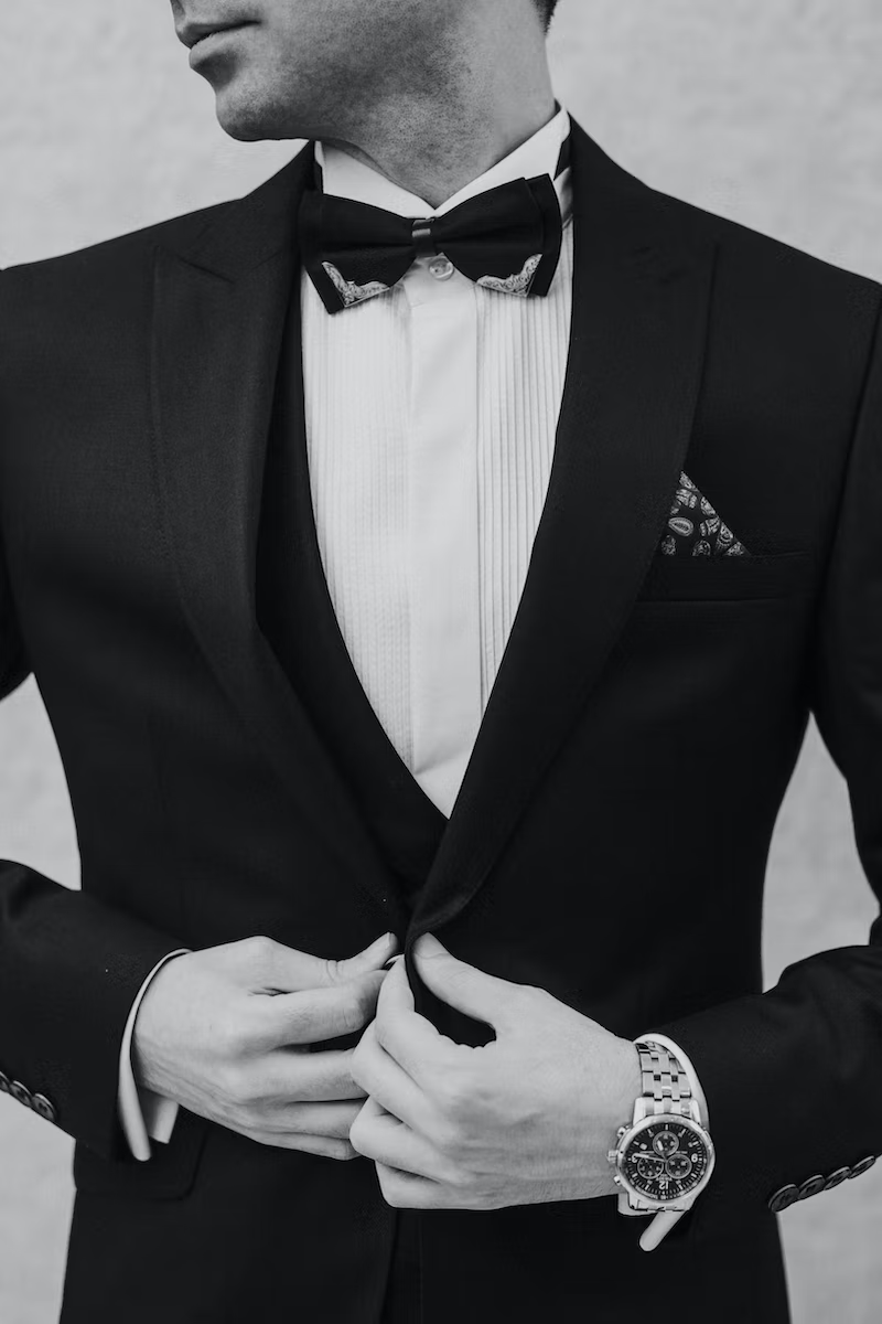  A man posing for a photo wearing a tuxedo