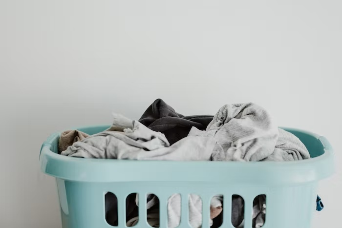 : A dirty pile of laundry in a basket