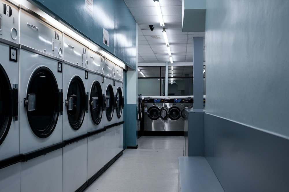 Dryers lined up at a professional dry cleaning and pressing service in DC