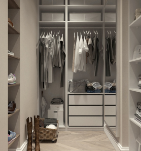 A neatly organized walk-in closet with clothes on hangers and shoes on racks