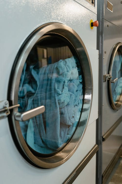 Blue clothes being washed at a professional cleaning service