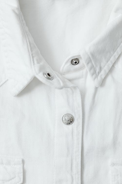 White shirt with a collar and top button open