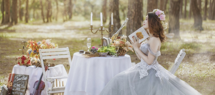 bride wearing white wedding sitting outdoors