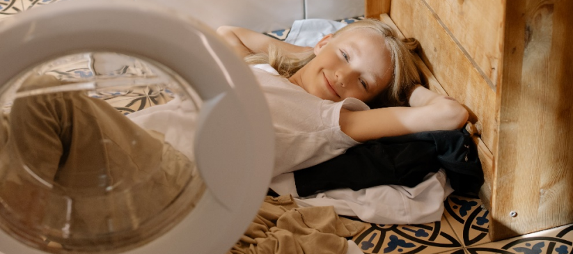 Girl lying on unwashed laundry