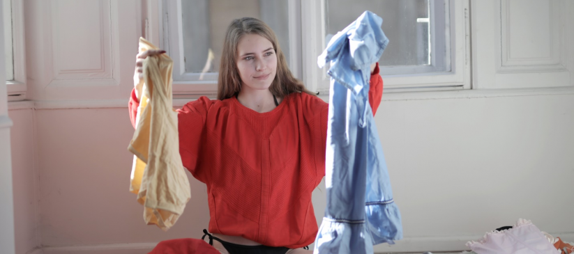 A girl sitting sorting her laundry