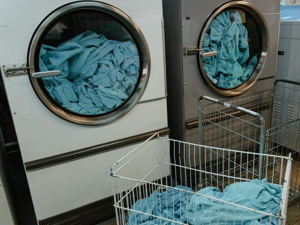 White and gray energy-efficient washing machine with blue fabrics inside