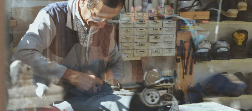 A shoe repair expert working with shoes in his workshop